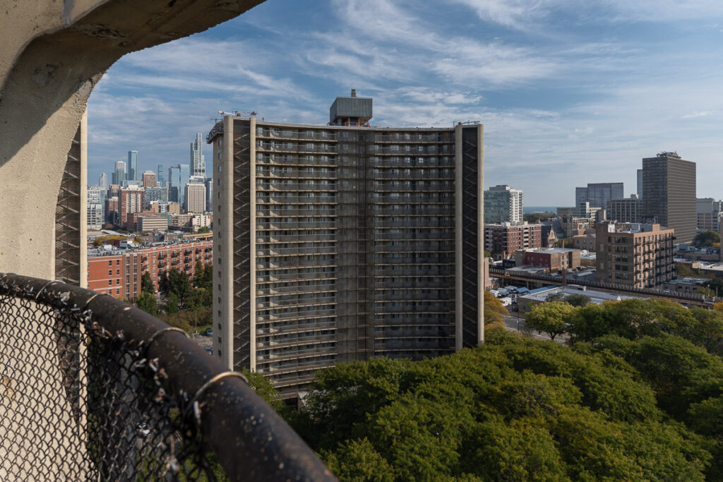 The east residential block through an open-air window in the west tower.